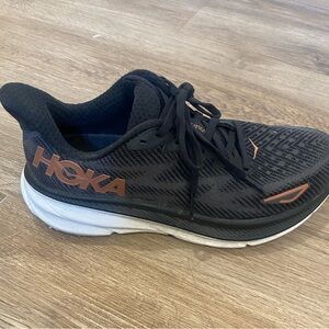 Hoka Black and Gold Womens Clifton. Worn in good worn condition.